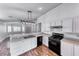 Kitchen featuring a breakfast bar, white cabinetry, laminate counters, black appliances, and luxury vinyl plank flooring at 4837 Morning Splash Ave, Las Vegas, NV 89131