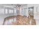Bright and airy living room with sleek hardwood floors, a ceiling fan and a large window at 4837 Morning Splash Ave, Las Vegas, NV 89131