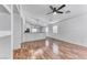 A well lit living room with hardwood floors looking into the kitchen, creating an open and inviting space at 4837 Morning Splash Ave, Las Vegas, NV 89131