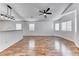 Bright, open-concept living area with ceiling fan, hardwood floors, and views of the kitchen at 4837 Morning Splash Ave, Las Vegas, NV 89131