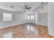 Spacious living room with hardwood floors, ceiling fan and natural light for a welcoming atmosphere at 4837 Morning Splash Ave, Las Vegas, NV 89131