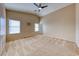 Spacious main bedroom featuring plush carpet, vaulted ceilings, a ceiling fan, and neutral-colored walls at 4837 Morning Splash Ave, Las Vegas, NV 89131
