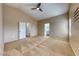 Large main bedroom with plush carpet, high ceilings, a ceiling fan, and an en-suite bathroom at 4837 Morning Splash Ave, Las Vegas, NV 89131