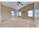 Vaulted main bedroom with neutral walls, plush carpet, ceiling fan, and en-suite bathroom access at 4837 Morning Splash Ave, Las Vegas, NV 89131