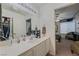 Bright bathroom featuring vanity and storage; view into bedroom at 4861 S Torrey Pines Dr # 106, Las Vegas, NV 89103