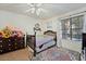 Bright bedroom featuring carpet, a ceiling fan, and a large window for ample natural light at 4861 S Torrey Pines Dr # 106, Las Vegas, NV 89103