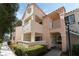 Charming condo featuring a light pink facade, balcony, and well-maintained landscaping at 4861 S Torrey Pines Dr # 106, Las Vegas, NV 89103
