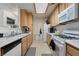 Functional kitchen with white appliances and light wood cabinetry at 4861 S Torrey Pines Dr # 106, Las Vegas, NV 89103