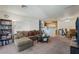 Comfortable living room with open floor plan, carpet, and view to dining area at 4861 S Torrey Pines Dr # 106, Las Vegas, NV 89103