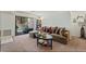 Carpeted living room showcasing a sliding glass door and comfortable lounge furniture at 4861 S Torrey Pines Dr # 106, Las Vegas, NV 89103