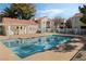 Community pool with clear blue water, surrounded by a concrete deck and white metal fencing at 4861 S Torrey Pines Dr # 106, Las Vegas, NV 89103