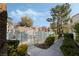 Community pool area featuring a fence, mature trees, and several community buildings at 4861 S Torrey Pines Dr # 106, Las Vegas, NV 89103