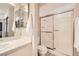 Clean bathroom featuring a shower with sliding glass doors, a toilet, and a sink at 4899 S Torrey Pines Dr # 104, Las Vegas, NV 89103