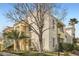 Beautiful condo features a private balcony, stucco finish, and mature palm trees at 4899 S Torrey Pines Dr # 104, Las Vegas, NV 89103