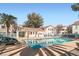 Relaxing community pool with clear blue water and ample space for lounging on a sunny day at 4899 S Torrey Pines Dr # 104, Las Vegas, NV 89103