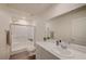 Bright white bathroom with a glass shower, toilet, modern vanity and faucet, and wood-look floors at 542 Foothill Cove Ln, Henderson, NV 89002