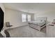 Bedroom features a large window, gray carpet, and a wood paneled bed frame at 542 Foothill Cove Ln, Henderson, NV 89002