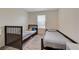 Bedroom featuring twin beds, carpet floors, and closet with sliding doors at 542 Foothill Cove Ln, Henderson, NV 89002