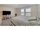 Bright bedroom featuring two windows, soft carpet, and a large bed with a floral comforter at 542 Foothill Cove Ln, Henderson, NV 89002