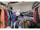 Walk-in closet with hanging clothes and shelves at 542 Foothill Cove Ln, Henderson, NV 89002