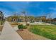Well maintained common area with lush green grass and a sidewalk leading through the landscape at 542 Foothill Cove Ln, Henderson, NV 89002