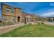 Well-maintained townhome exterior with a neat lawn and landscaping, enhancing curb appeal at 542 Foothill Cove Ln, Henderson, NV 89002