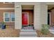 Inviting front entrance with a bright red door, stone accents, and a covered entryway at 542 Foothill Cove Ln, Henderson, NV 89002