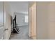 View of the hallway and a carpeted room with a window and a mounted TV on a stand at 542 Foothill Cove Ln, Henderson, NV 89002
