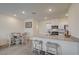 Bright kitchen featuring a breakfast bar, stainless steel appliances, and an adjacent dining area at 542 Foothill Cove Ln, Henderson, NV 89002