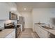 Modern kitchen features laminate flooring, stainless steel appliances, and bright white cabinetry at 542 Foothill Cove Ln, Henderson, NV 89002