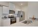 Efficient kitchen featuring white cabinets and modern stainless steel appliances at 542 Foothill Cove Ln, Henderson, NV 89002