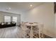 Brightly lit dining area with seating and sleek hardwood floors, perfect for entertaining and daily living at 542 Foothill Cove Ln, Henderson, NV 89002