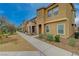 Exterior street view of modern townhomes with desert landscaping and a walking path at 542 Foothill Cove Ln, Henderson, NV 89002