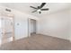 This bedroom has neutral carpet, a ceiling fan, and a closet for optimal storage at 6320 Hobart Ave, Las Vegas, NV 89107