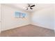 Comfortable bedroom featuring new carpet, ceiling fan, and a bright window at 6320 Hobart Ave, Las Vegas, NV 89107