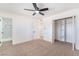 This bedroom features neutral carpet, a ceiling fan, a closet with shelving, and adjoined bathroom at 6320 Hobart Ave, Las Vegas, NV 89107