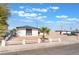 Single story home with gravel yard, palm tree, and picket fence at 6320 Hobart Ave, Las Vegas, NV 89107