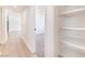 A hallway connects bedrooms and features shelving for storage at 6320 Hobart Ave, Las Vegas, NV 89107