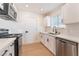 Modern kitchen with white cabinets, stainless steel appliances, and elegant black hardware at 6320 Hobart Ave, Las Vegas, NV 89107