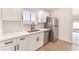 Updated kitchen boasts stainless steel appliances, white cabinets, and sleek countertops at 6320 Hobart Ave, Las Vegas, NV 89107