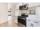 Bright kitchen with a breakfast bar and stainless steel appliances connecting to the living area at 6320 Hobart Ave, Las Vegas, NV 89107