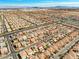 Expansive aerial view of a vibrant community with numerous homes, city skyline in the distance, and mountain backdrop at 6335 Mount Eden Ave, Las Vegas, NV 89139