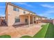 Charming home featuring a covered patio, green artificial turf, and ample outdoor space for relaxation at 6335 Mount Eden Ave, Las Vegas, NV 89139
