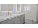 Bright bathroom featuring a double vanity with marble countertops and modern fixtures at 6335 Mount Eden Ave, Las Vegas, NV 89139