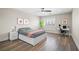 Cozy bedroom with a modern bed, a side table, and a work space with a desk under a large window at 6335 Mount Eden Ave, Las Vegas, NV 89139