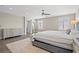 Airy bedroom featuring wood floors, neutral tones, large windows, and a comfortable king-sized bed at 6335 Mount Eden Ave, Las Vegas, NV 89139