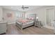 Comfortable bedroom with dresser, nightstand, ensuite bathroom, ceiling fan, and wood flooring at 6335 Mount Eden Ave, Las Vegas, NV 89139