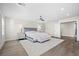 Spacious primary bedroom with a ceiling fan, plush rug, and stylish decor, creating a relaxing retreat at 6335 Mount Eden Ave, Las Vegas, NV 89139