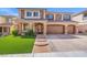 Attractive two-story home with a three-car garage, brick accents, manicured lawn, and inviting walkway at 6335 Mount Eden Ave, Las Vegas, NV 89139