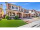 Beautiful two-story home with a brick and stucco exterior, tile roof, and manicured front lawn at 6335 Mount Eden Ave, Las Vegas, NV 89139